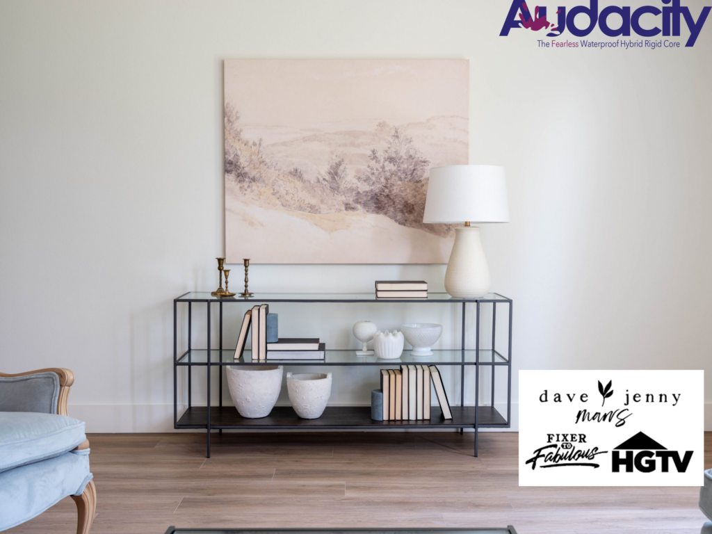 Metal console table with decor against a neutral wall; featured on HGTV's