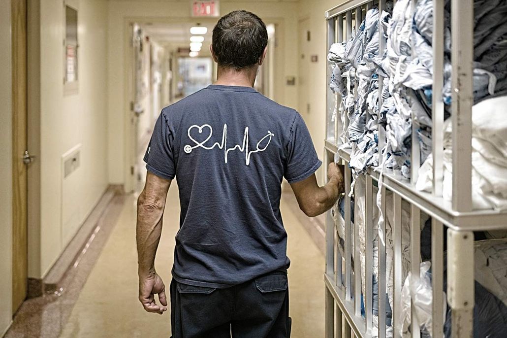 Housekeeping staff walks with linen cart