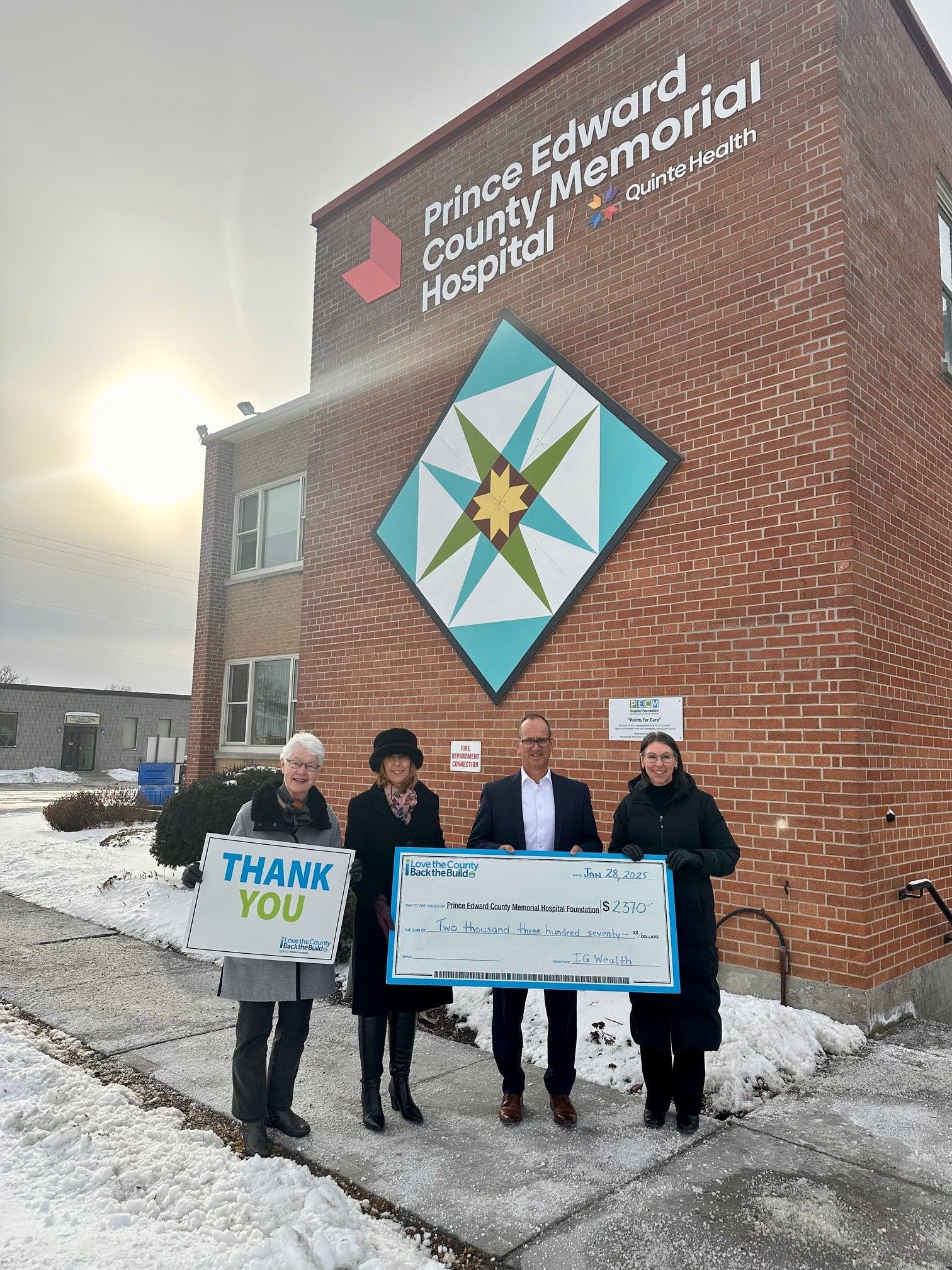 Cheque presentation photo outside of PECMH.