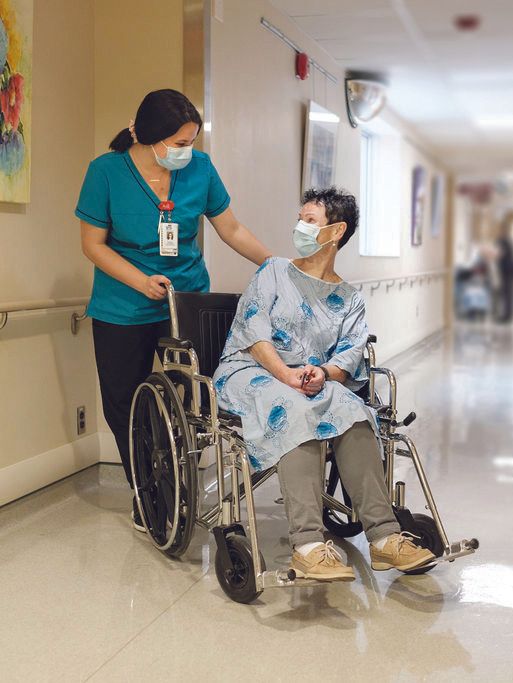 Nurse assists patient in wheelchair
