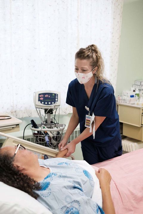 Nurse comforts patient at bedside