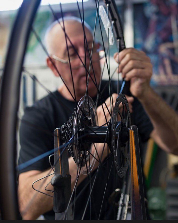 Person fixing bicycle tire