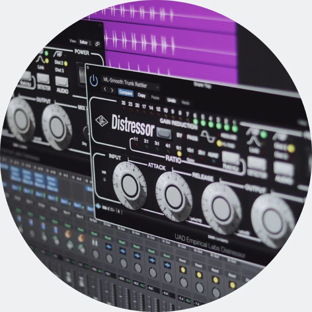 Close-up of a studio rack with a Distressor compressor unit, waveform visuals, and mixing console.
