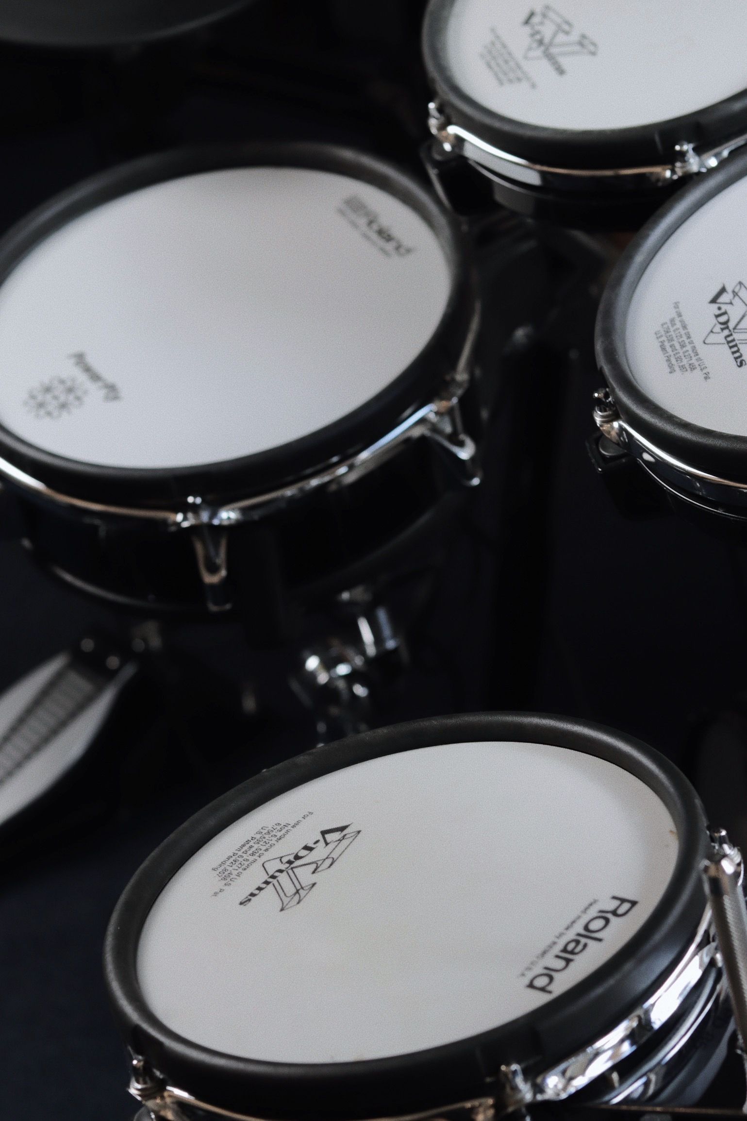 Drum set in a recording studio, with microphones. Drums are white sparkly.