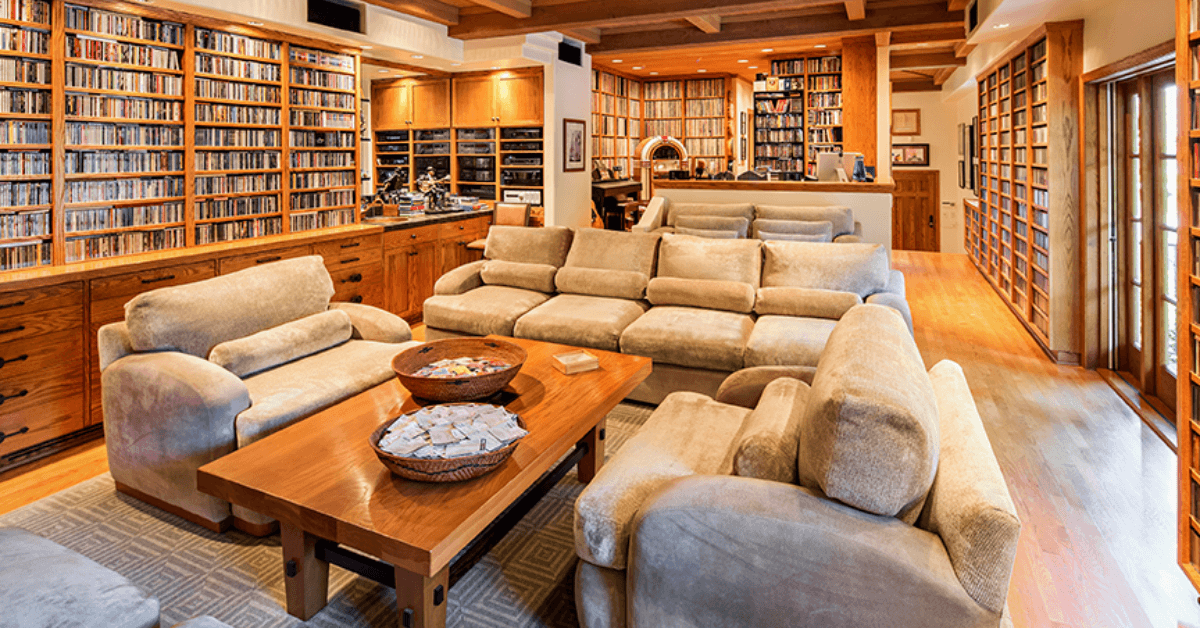 A living room filled with furniture and lots of bookshelves.