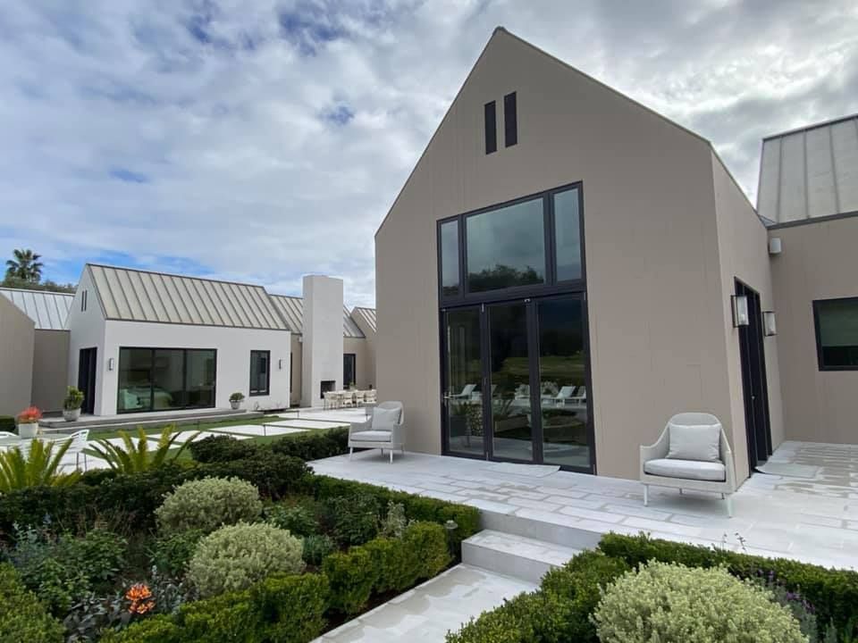 A large house with a roof that looks like a barn.