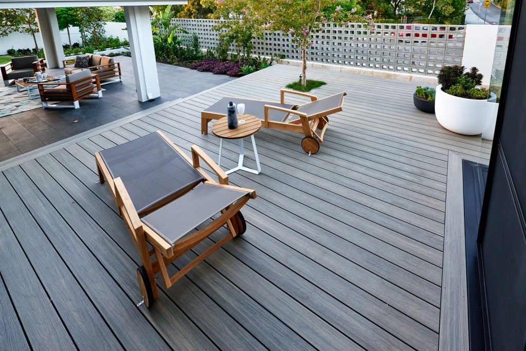 A deck with chairs and a table on it