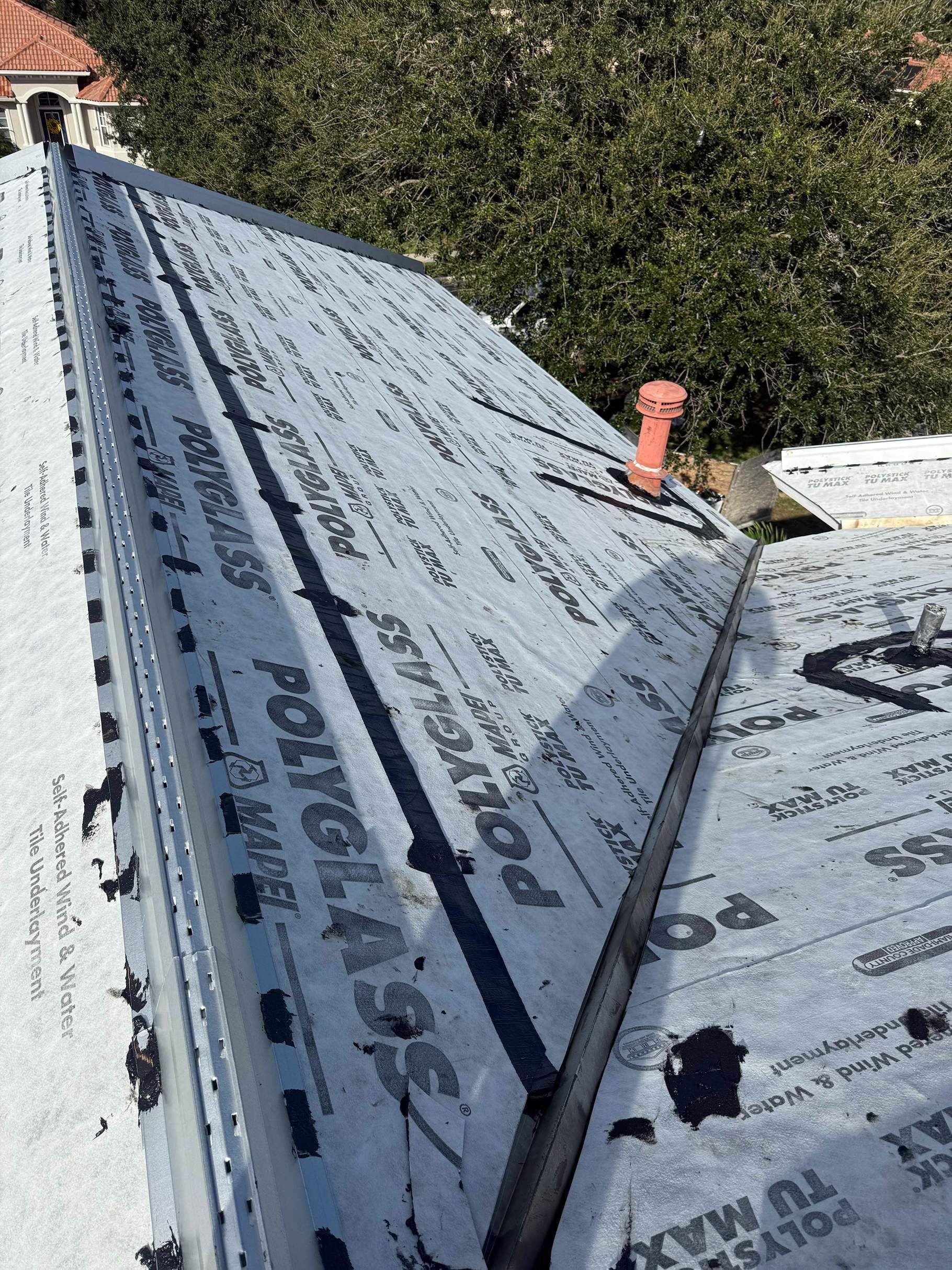 Roof covered in new Polyglass underlayment; construction in progress.
