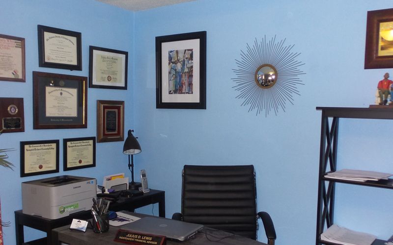 A blue office with a black chair and a printer