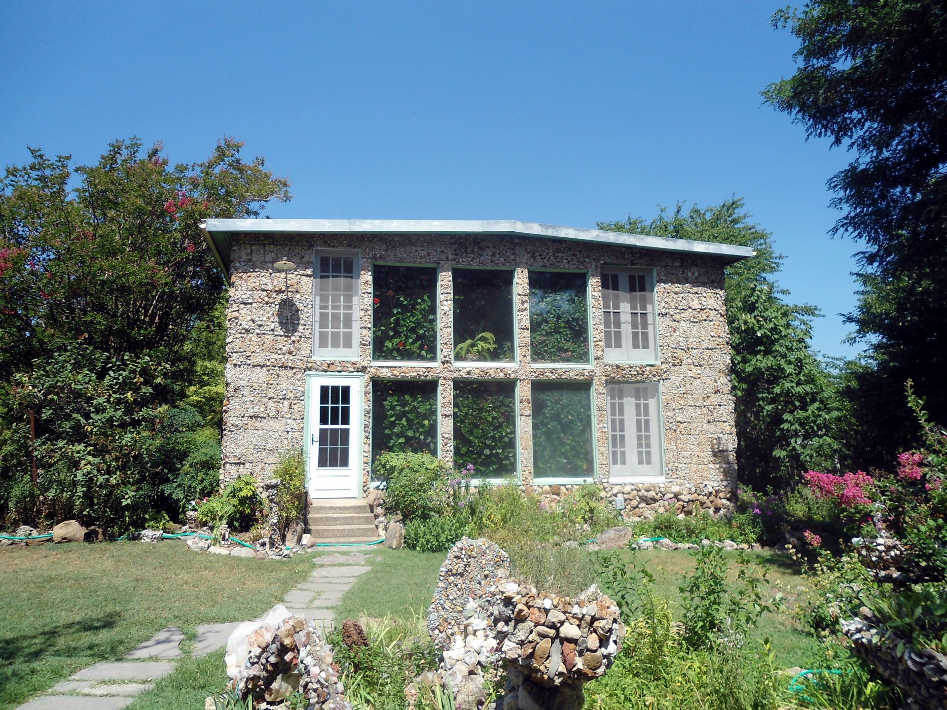 a large stone house with lots of windows and a white door