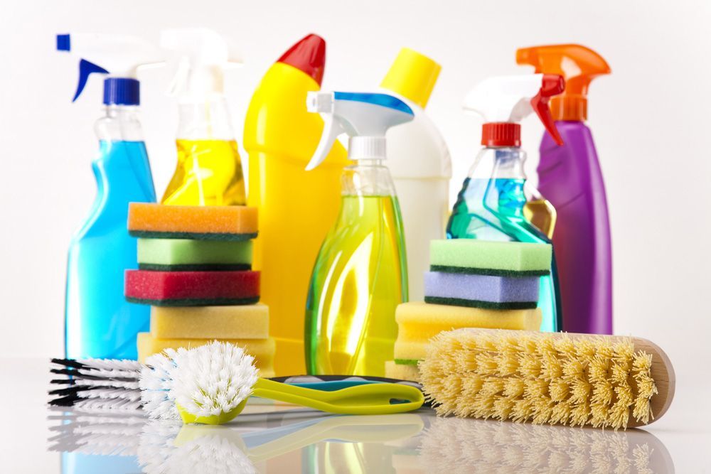 A Group of Cleaning Supplies Including Spray Bottles, Sponges, Brushes and Soap — Maid In Bowral in Moss Vale, NSW