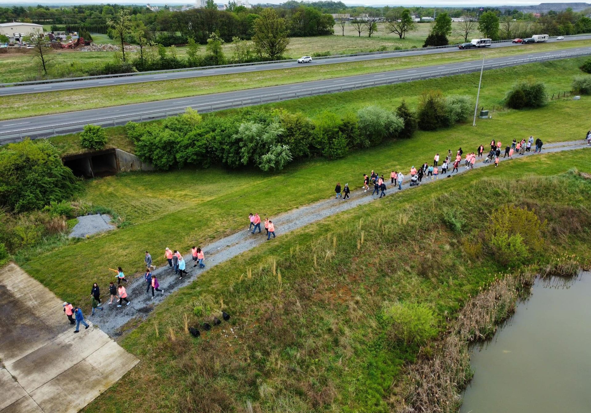 An aerial view of a group of people walking down a path.