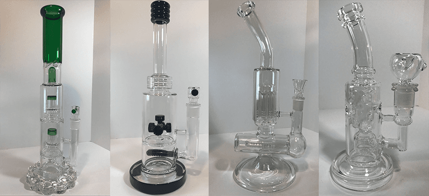 Three different types of glass bongs are sitting on a table