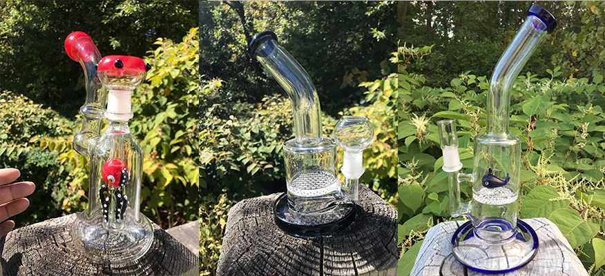 A person is holding a glass pipe in their hand