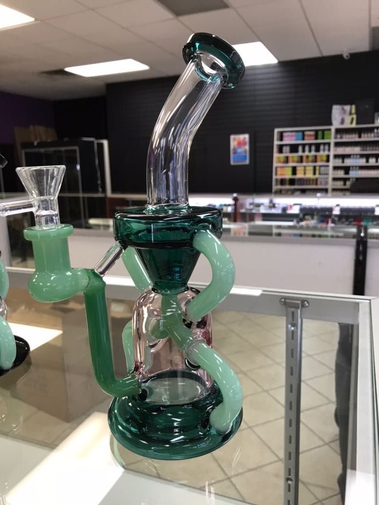 A green glass pipe is on display in a store
