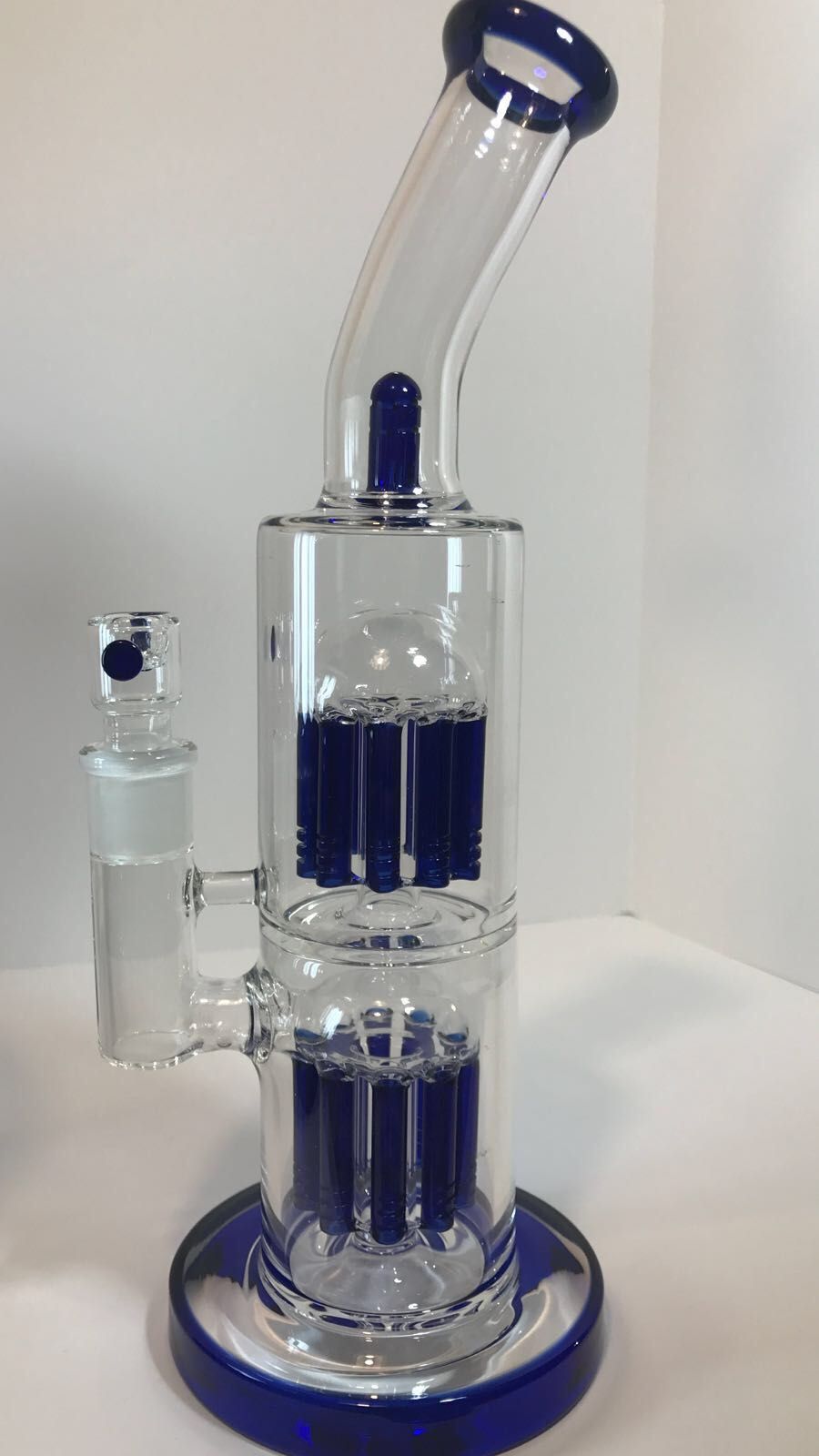 A blue glass bong is sitting on top of a white table