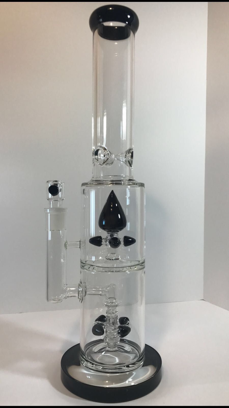 A glass bong is sitting on top of a white table