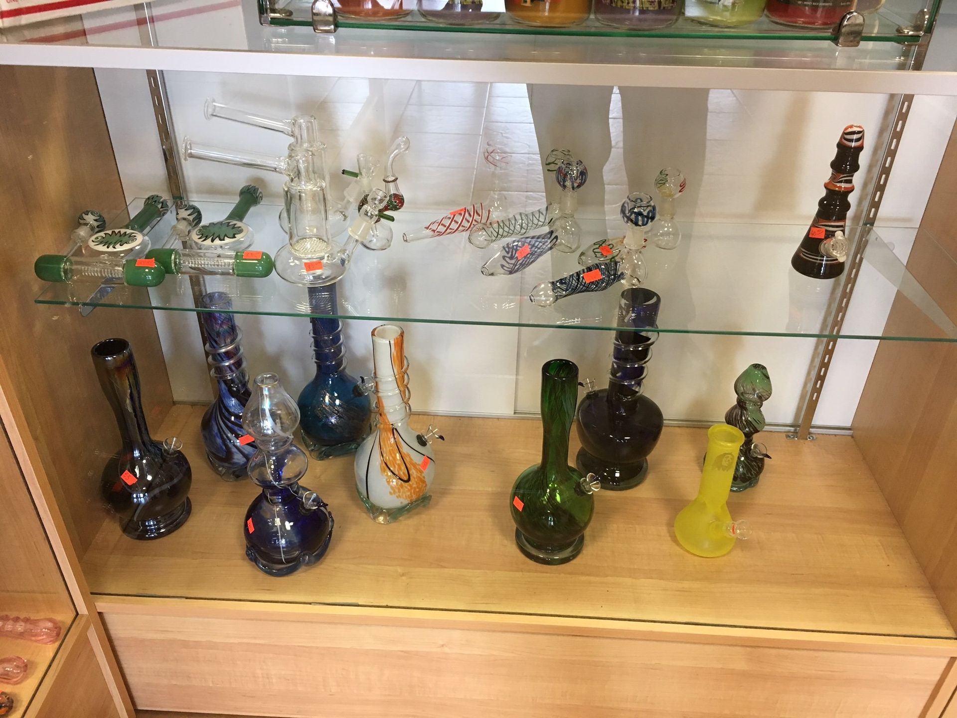 A display case filled with a variety of bongs and pipes