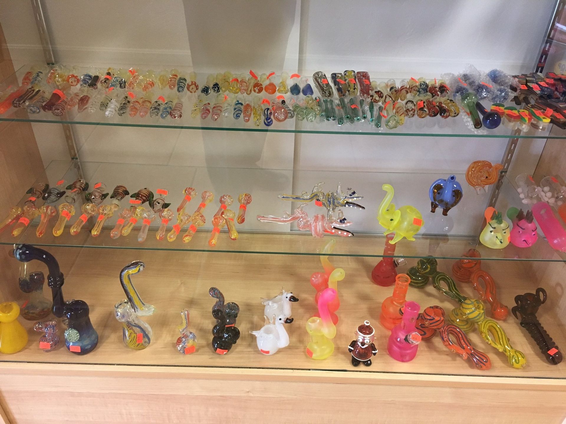 A display case filled with a variety of glass pipes