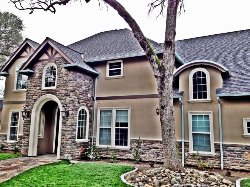 A large house with a tree in front of it