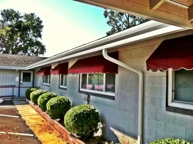 A building with red awnings on the windows