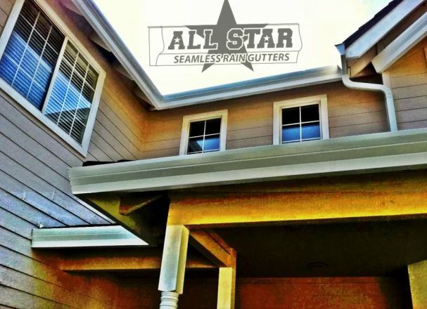 A house with all star seamless gutters written on it