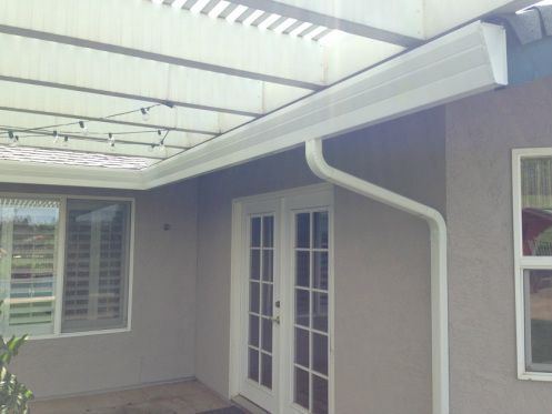 A house with a white gutter on the side of it