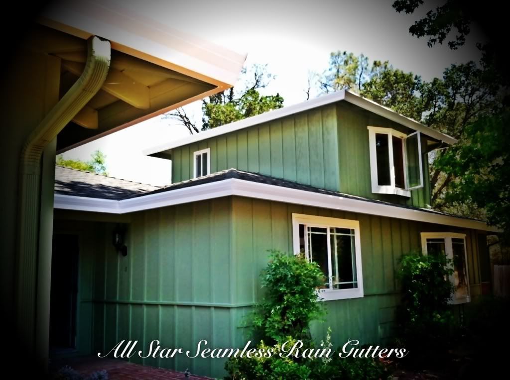 A green house with all star seamless rain gutters on it