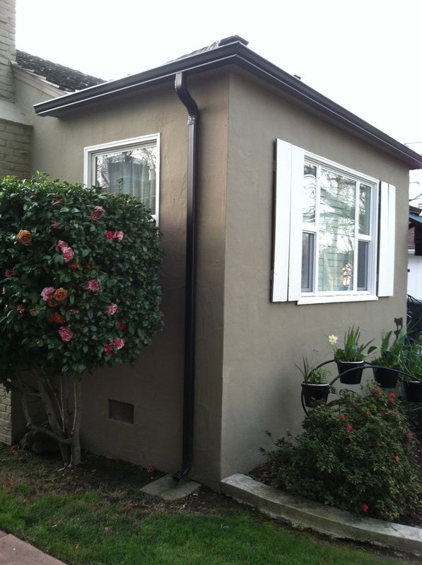 A house with a window and a gutter on the side