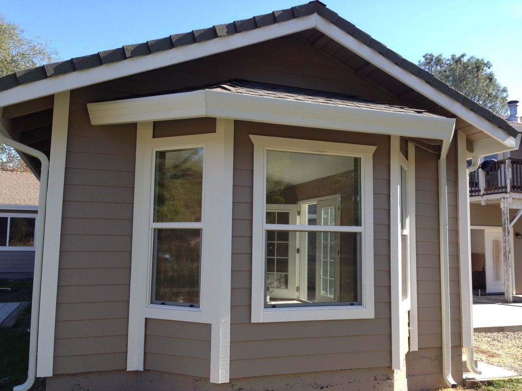 A small house with a large window on the side
