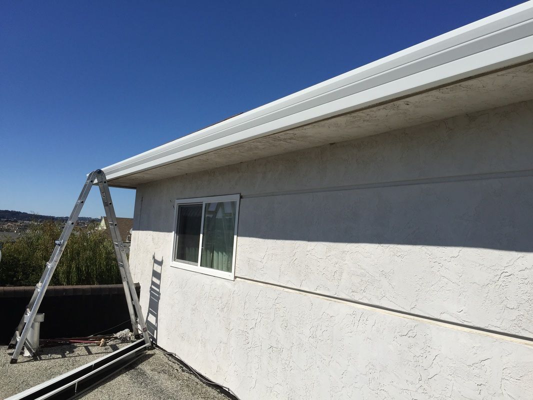 A ladder is leaning against the side of a house.
