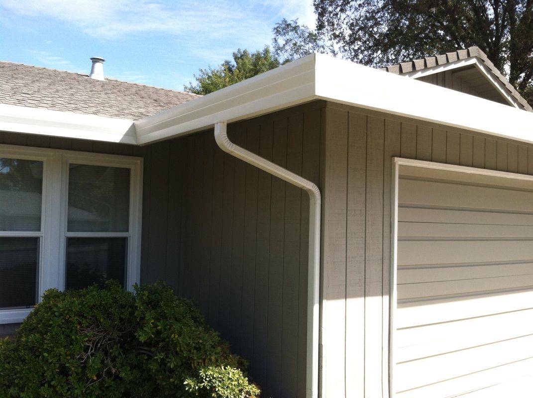 A house with a garage and a gutter on the side
