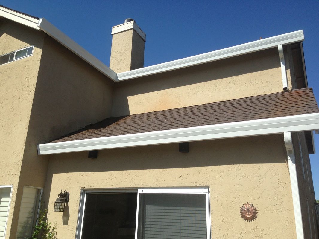 A house with a sliding glass door and a brown roof