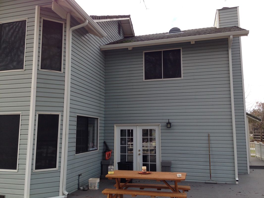 A house with a picnic table in front of it