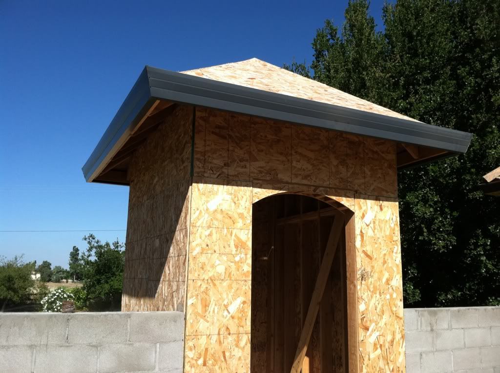 A small wooden building under construction with a roof