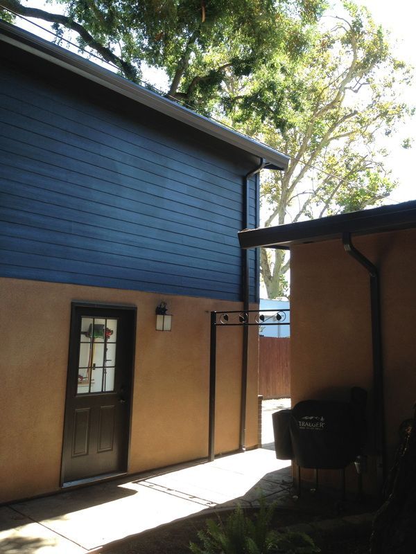 A house with a blue siding and a black door