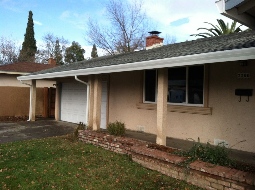 The front of a house with a porch and a garage