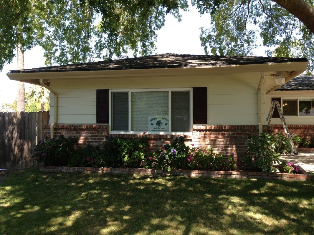 A white house with a ladder in front of it