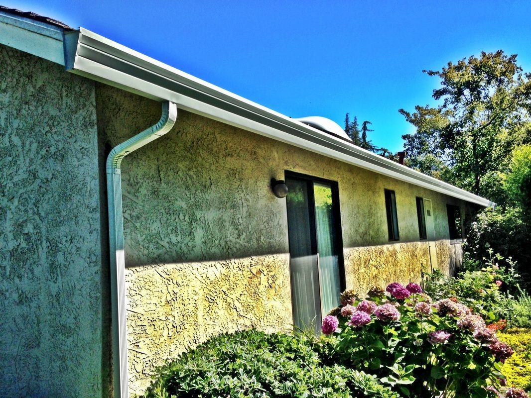 A house with a gutter on the side of it