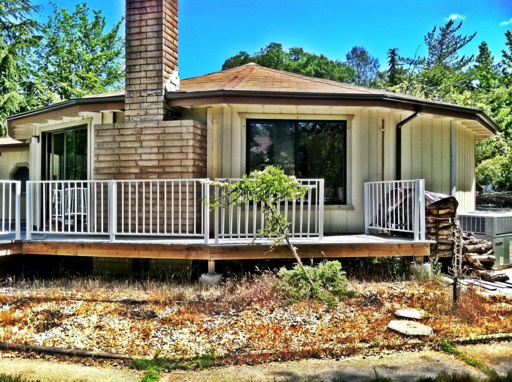 A house with a large deck and a chimney