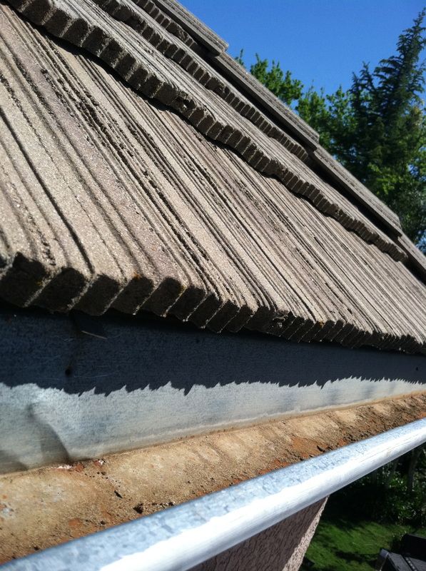 A close up of a gutter on a roof