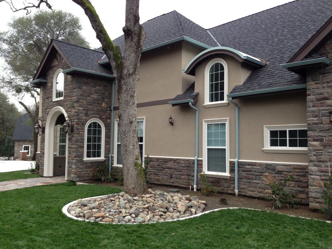 A large house with a tree in front of it