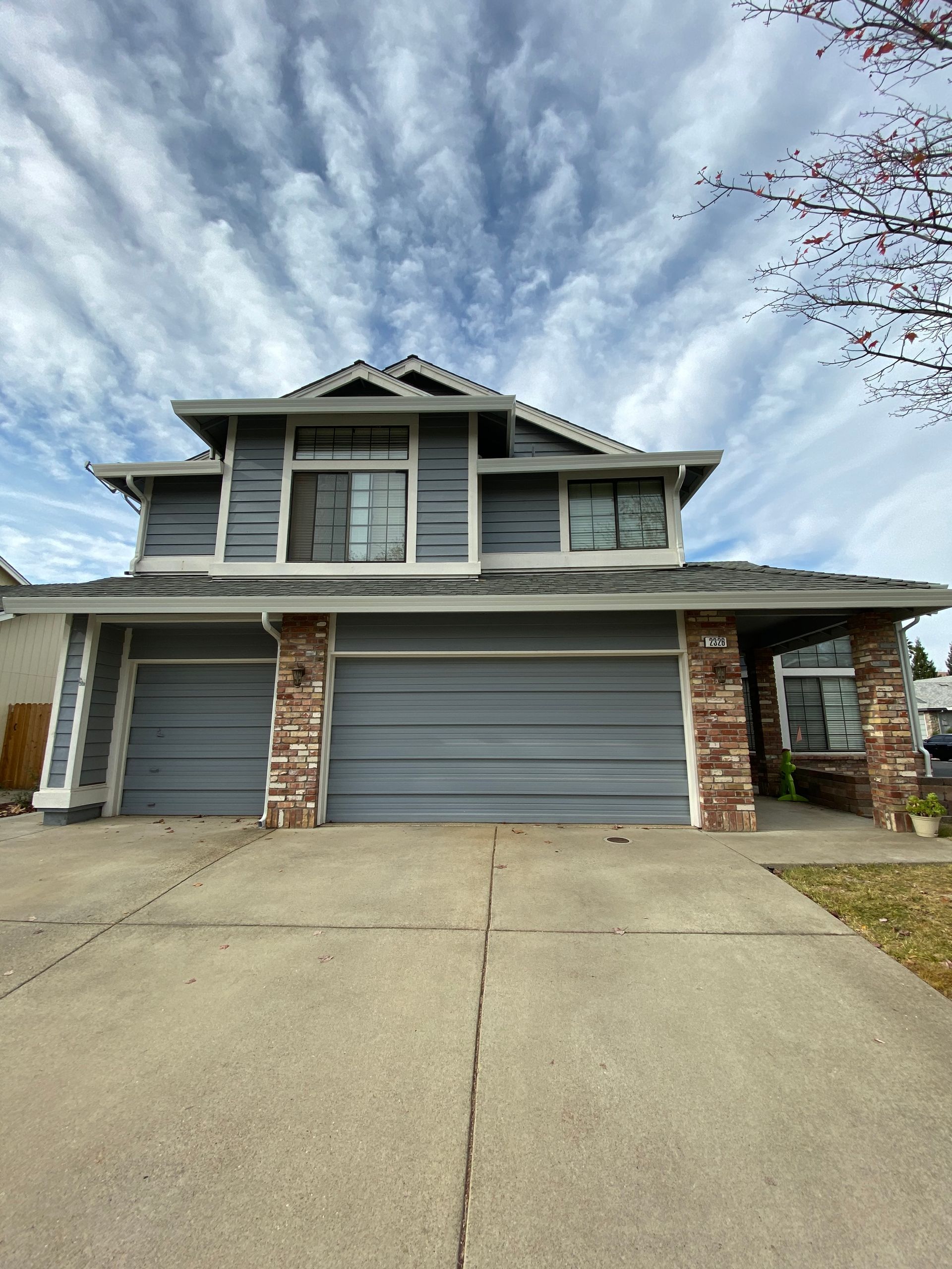 The front of a house with a blue garage door