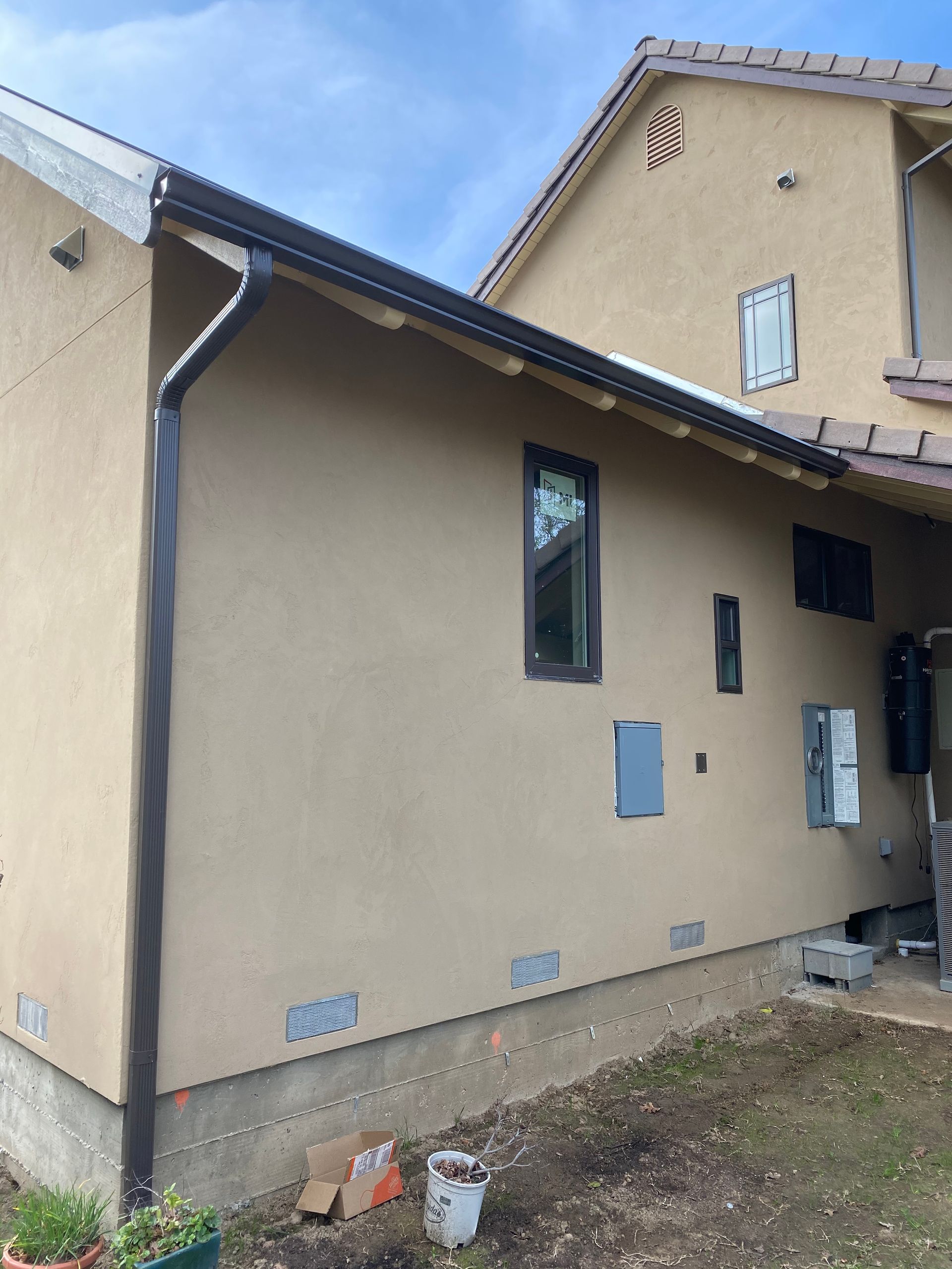 A house with a gutter on the side of it