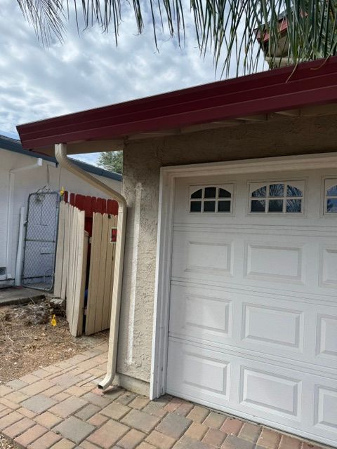 A white garage door with a red roof