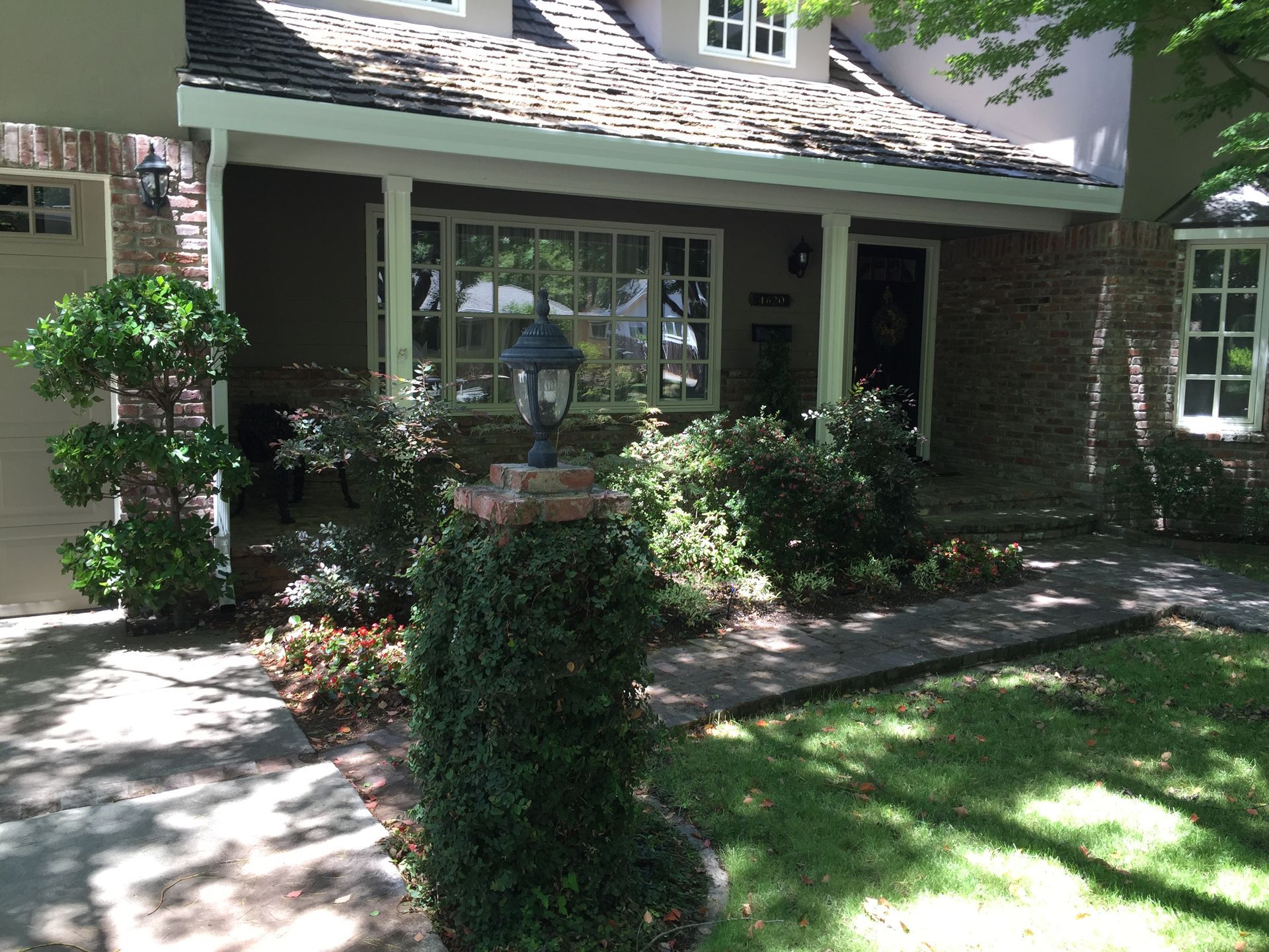 A house with a porch and a lamp in front of it. Gutter Gaurd installation 