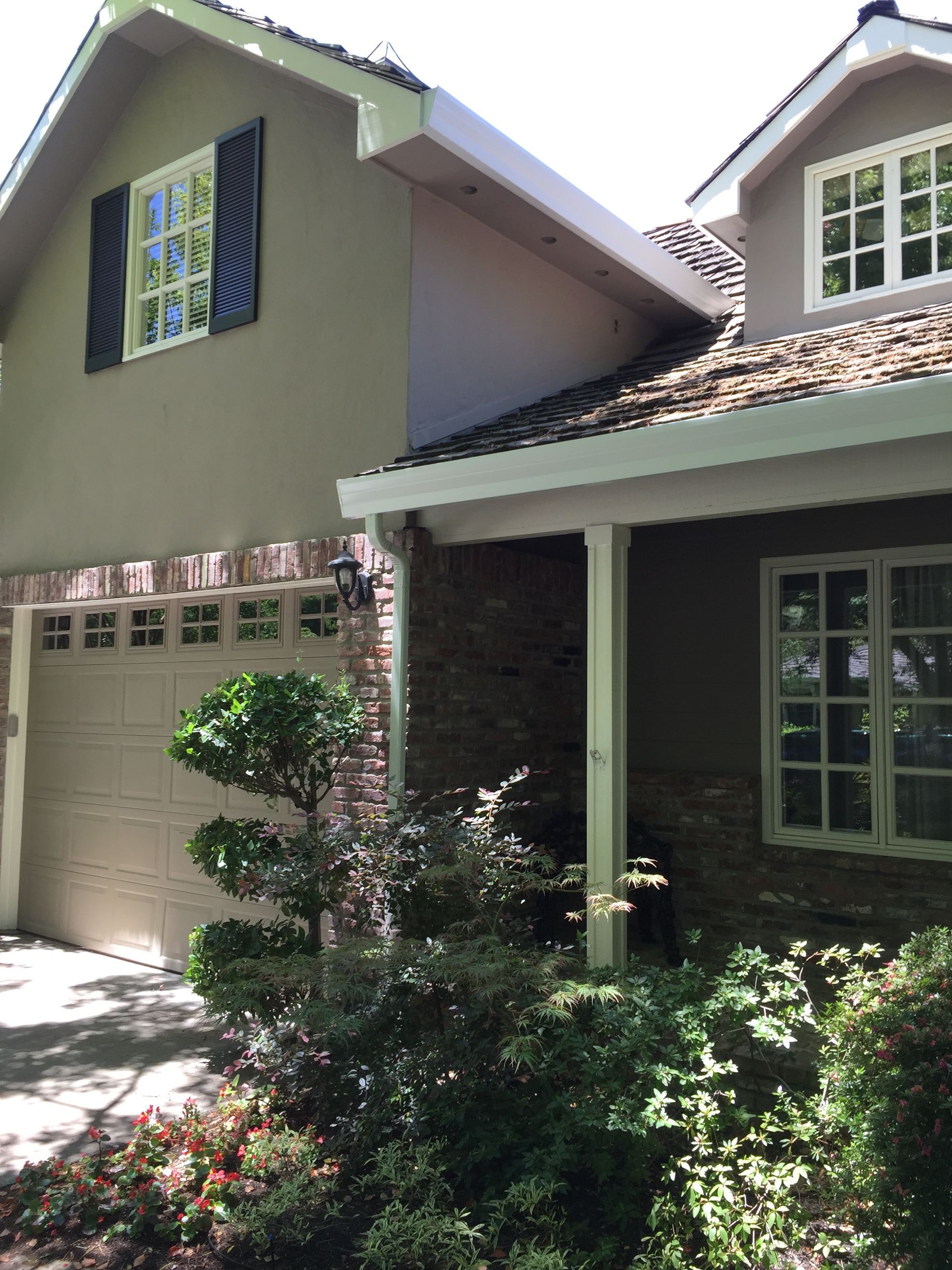 The front of a house with a garage door and a porch