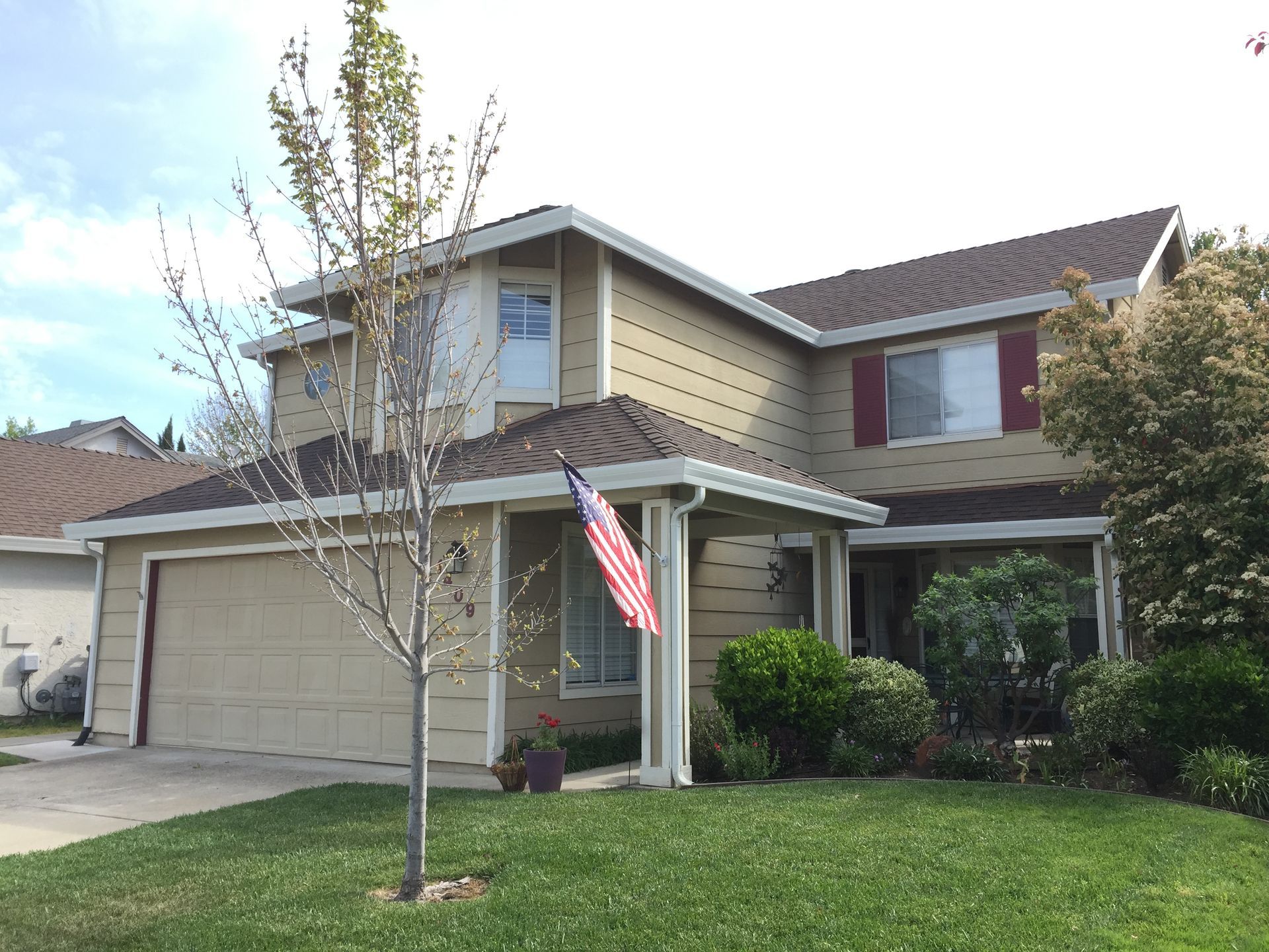 A house with a sliding glass door and a brown roof