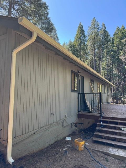 A house with a gutter on the side of it