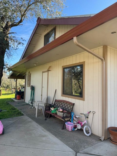 A house with a bench and a bicycle in front of it